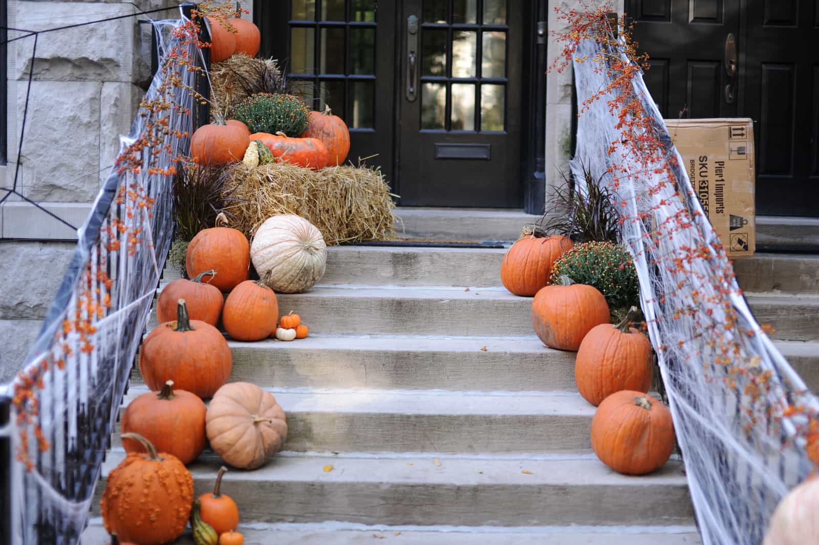 Pumpkins arranged on a front porch in autumn